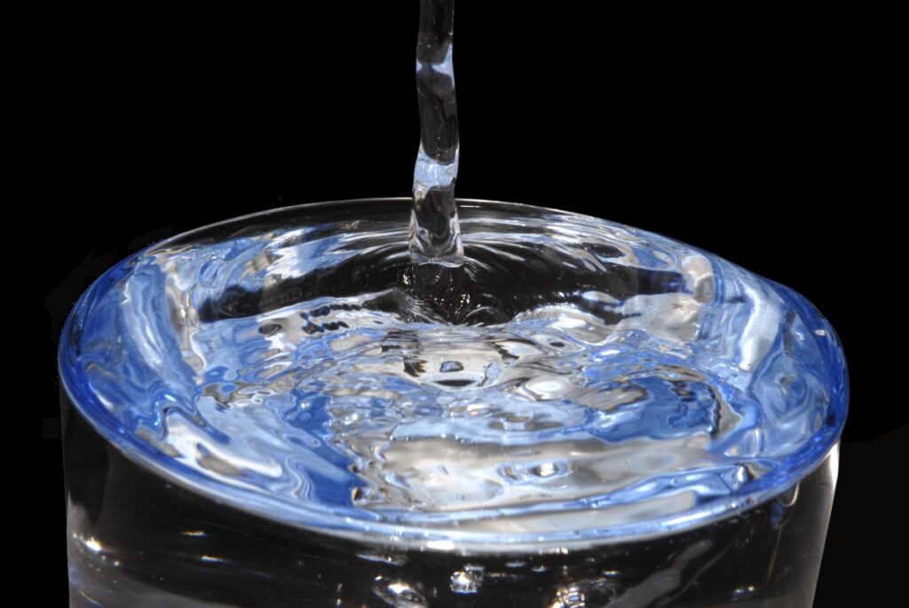 clear water pouring over a glass